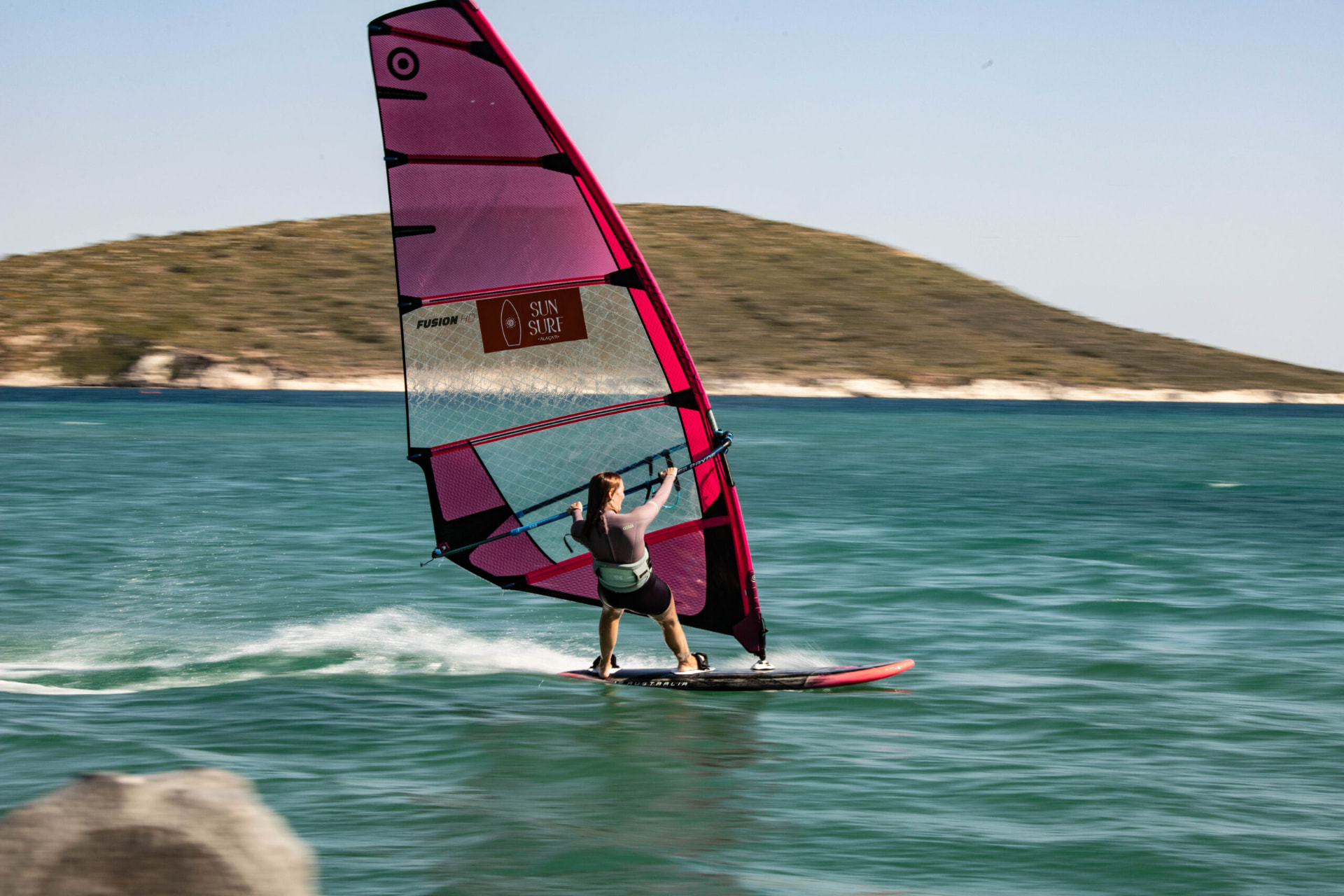 Windsurfer gliding across the Aegean water at SunSurf Alaçatı